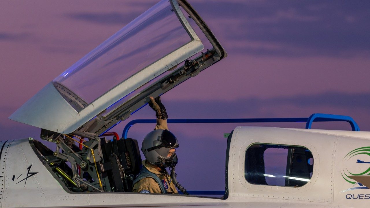 Pilot sits in the X-59 at sunset.