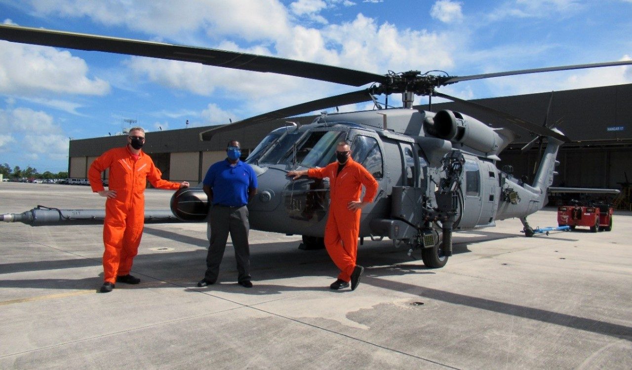 Sikorsky Pilots Bob Arsenault and Ben Williamson with Julian Cox, hangar manager, pose with the Air Force’s Jolly Green II